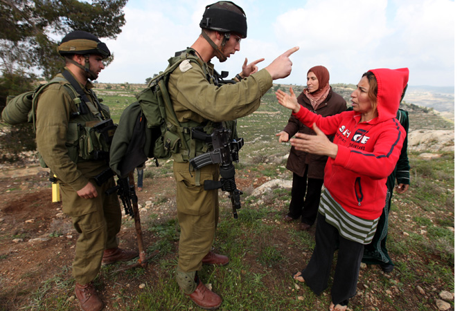 Israeli solider arguing with a protestor