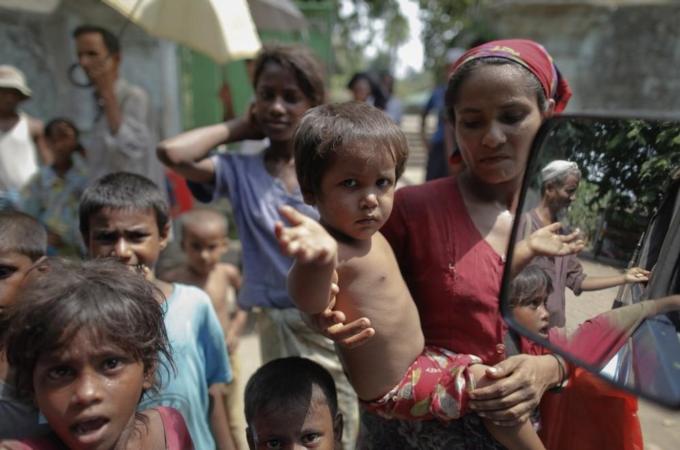 Rohingya people beg outside a mosque after Friday prayers in Sittwe