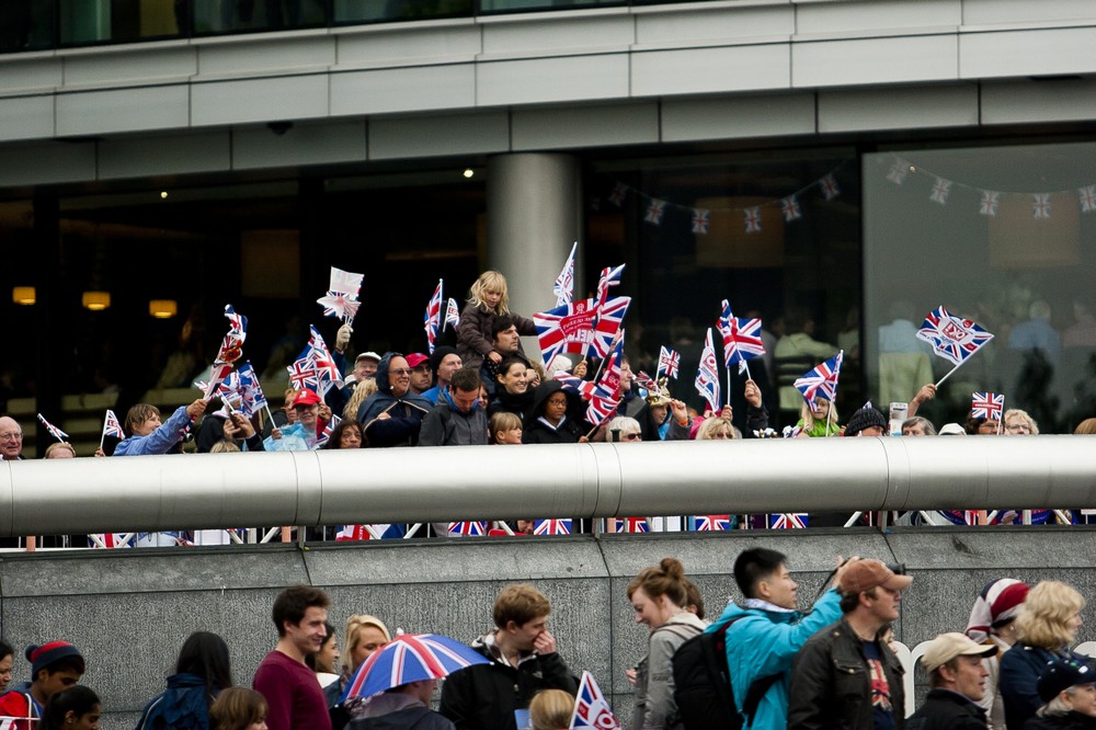 Crowds of people gathered in front of London(***)s City Hall to see the queen as she cruised along on the Thames River for the Diamond Jubilee, marking her 60th year on the throne. She is only the second monarch in UK history to have achieved the milestone.