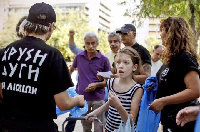 Members of Greek ultra right wing party Golden Dawn distribute food products to Greek citizens in central Athens, Greece