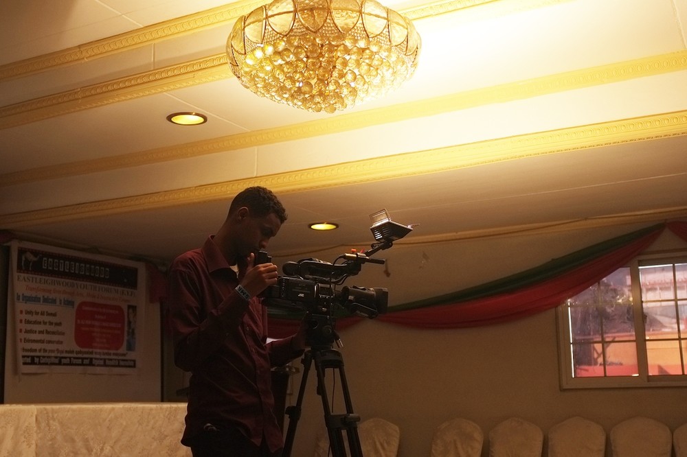 A videographer sets up his camera at a memorial service to honour the late Somali journalist Ali Sharmarke, assassinated by al-Shabab militants five years ago.