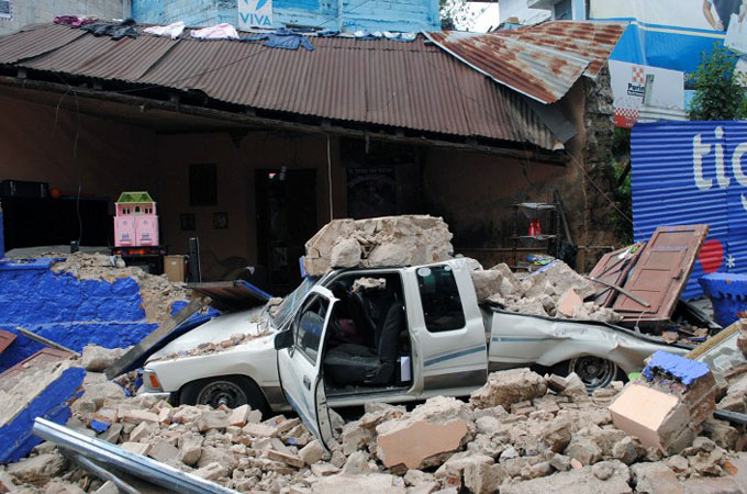 a truck hit by rubble in an earthquake in Guatemala