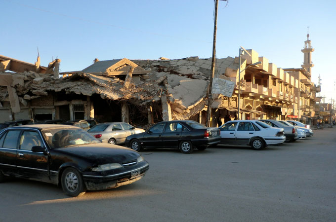 Bombed buildings like this one in Fallujah litter Iraq, and remain toxic sites that likely continue to cause illnesses [Dahr Jamail/Al Jazeera]
