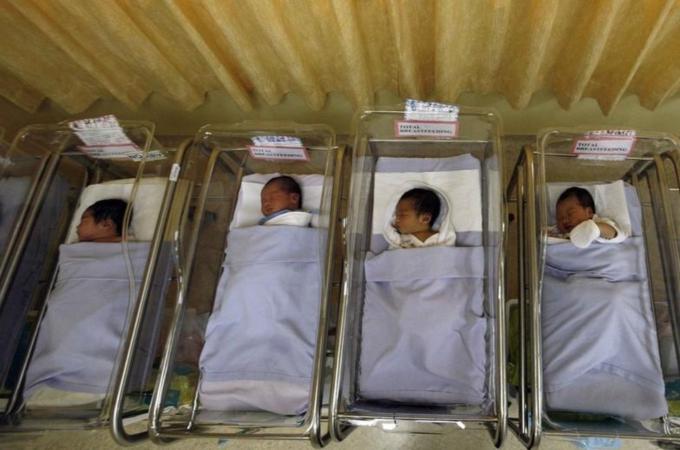 File photo shows babies lying in cots at a maternity ward in Singapore