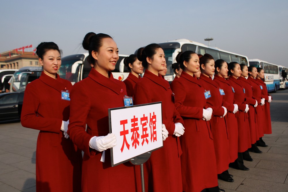 A group of hostesses pose in front of buses at Tiananmen Square in Beijing. The congress will complete China(***)s leadership transition that began with a Communist Party 
congress in November 2012.