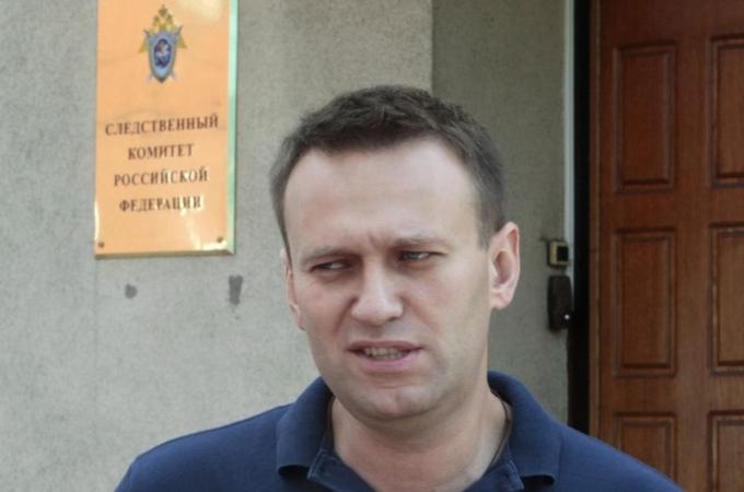 Russian anti-corruption blogger Navalny speaks to the media outside the Federal Investigation Commission building in Moscow