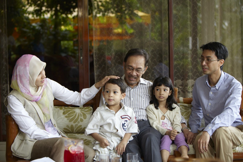 Opposition leader Anwar Ibrahim relaxes with his family before the final stretch of the election campaign. He is pictured here with his daughter, Nurul Izzah, her husband and their two children.