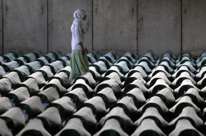 A Bosnian woman tries to find the coffin of her relative in Memorial Center Potocari near Srebrenica
