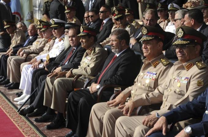 Egypt''s new President Mursi and Field Marshal Tantawi, head of Egypt''s ruling SCAF, attend a ceremony where the military handed over power to Mursi at a military base in Hikstep