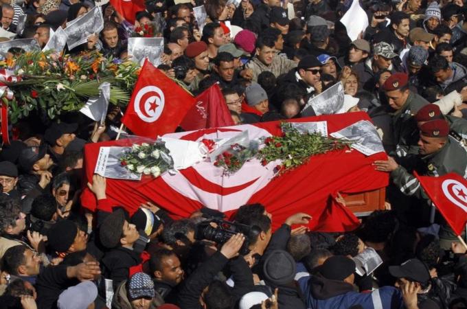 Soldiers help mourners carry the coffin of slain opposition leader Chokri Belaid during his funeral procession towards the nearby cemetery of El-Jellaz, where he is to be buried, in the Jebel Jelloud district of Tunis