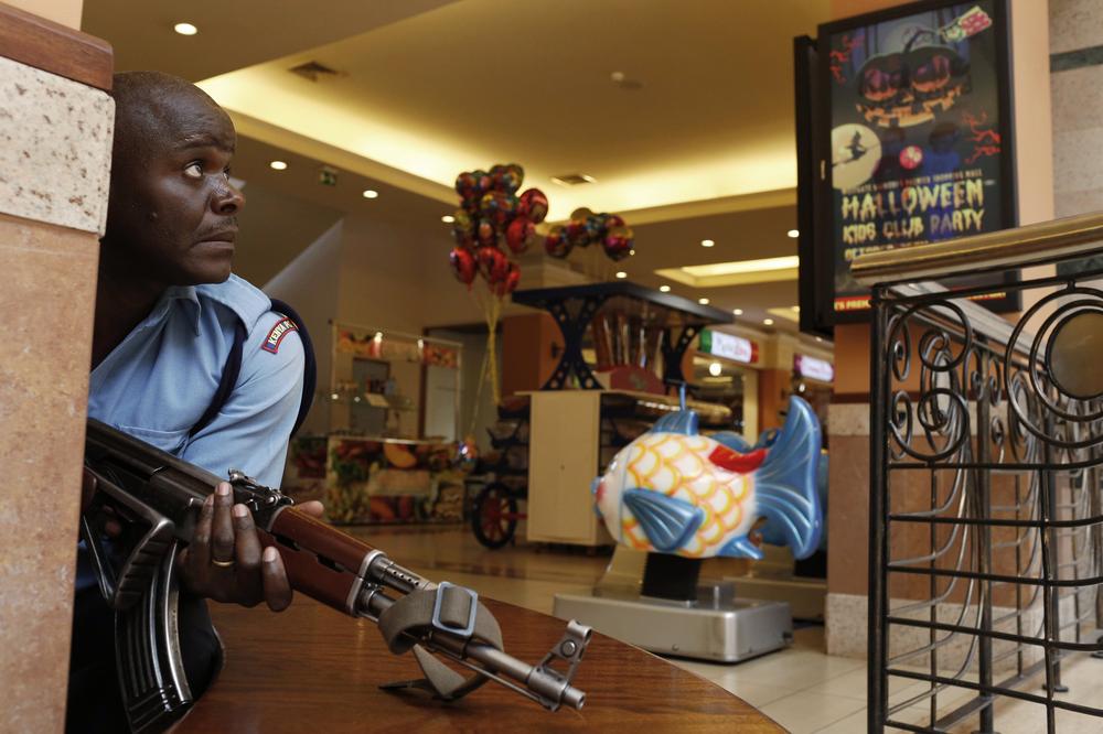 A police officer tries to secure an area inside the Westgate Shopping Centre where gunmen went on a shooting spree in Nairobi