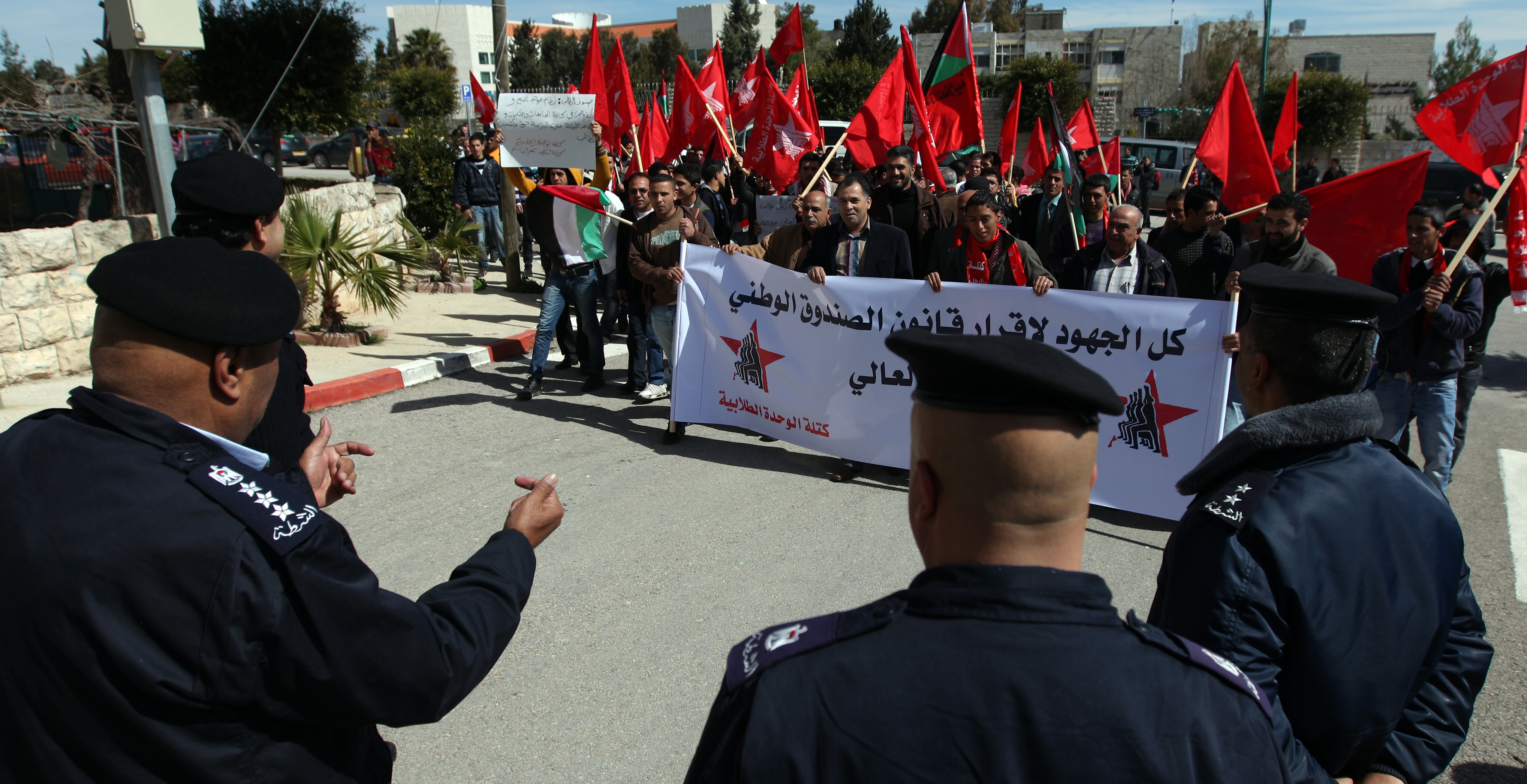 Students from Birzeit University protest high costs in front of the Prime Minister's Office [EPA]