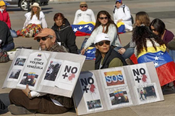 Venezuela's polarisation is often thought to have begun with former President Hugo Chavez's confrontational strategy to redistribute power and resources, writes McCoy [EPA]