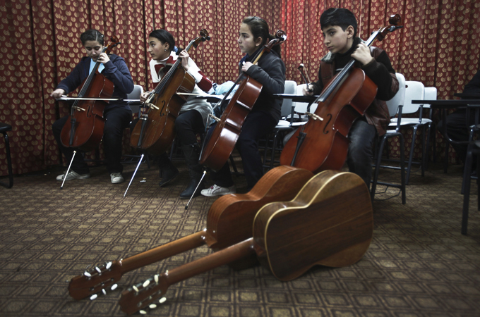 Approximately 200 Palestinian children attend classes at the Gaza Music School [EPA]