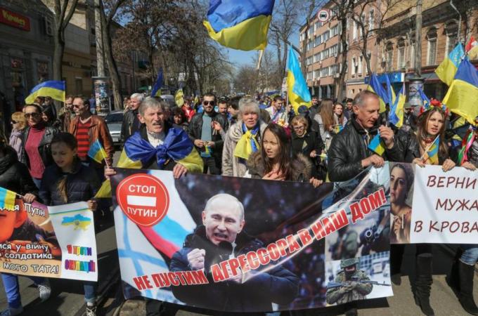 Ukrainians carry anti-Russian placards during a march in Odessa, Ukraine [EPA]