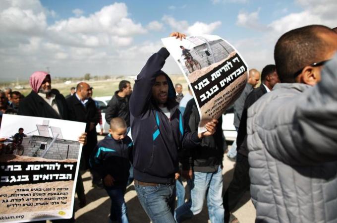 Bedouin Israeli youths march with banners calling on Israel to stop the house demolition policy [AFP/Getty Image]