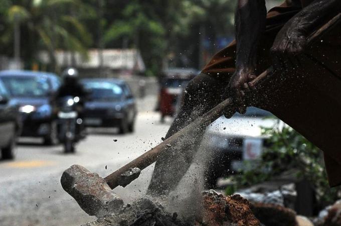 A Sri Lankan labourer works at a construction site in Colombo [AFP]