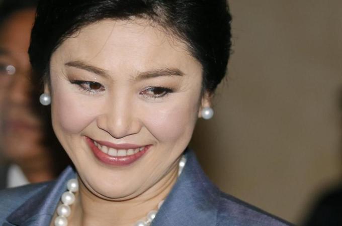 Thai caretaker Prime Minister Yingluck Shinawatra smiles as she arrives for a court case at the Constitutional Court in Bangkok [EPA]