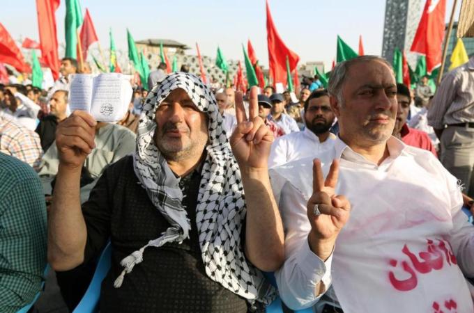 Iranians flash the sign of victory during a protest against ISIL's offensive in Iraq on June 24 in Tehran [AFP]