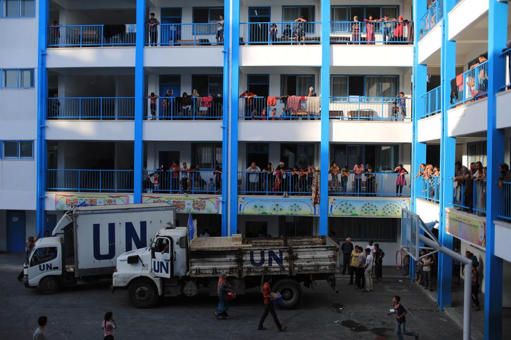 United Nations employees distribute food to Palestinians at a school in Gaza.