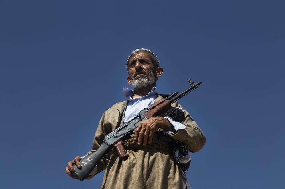 <p>A volunteer in Kurdish forces stands guard on the roof of a building on the outskirts of Makhmour. The Kurdish Peshmerga have prohibited young volunteers from joining the fight against the Islamic State group.</p>