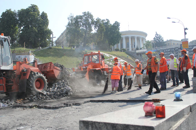 Workers in Maidan Square lay bricks after protesters used them as weapons [Kristina Jovanovski/Al Jazeera]