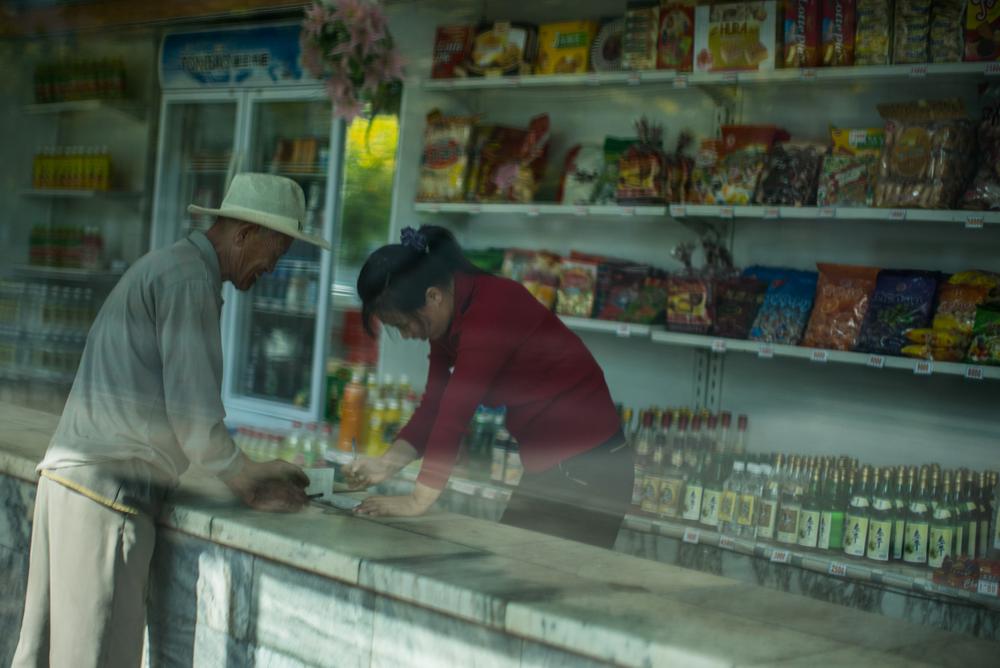 A man buys groceries made in China at a store in Pyongyang.