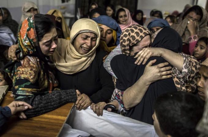 Women mourn Mohammed Ali Khan, 15, a student who was killed during an attack by Taliban gunmen [Reuters]