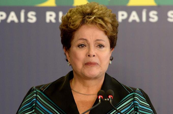 President Rousseff cries while delivering a speech presenting the final report of the National Truth Commission [AFP]