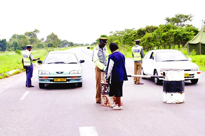Police 'roadblocks' in Zimbabwe with officers demanding bribes are scaring off tourists [Gift Phiri/Al Jazeera]