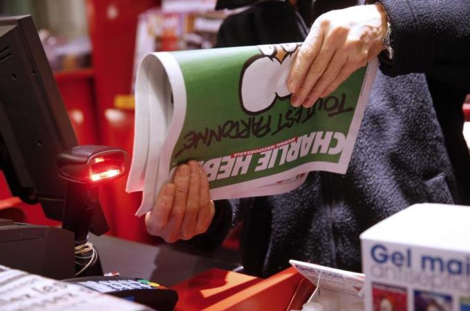 A newspaper dealer sells the new edition of the French satirical newspaper Charlie Hebdo [EPA]