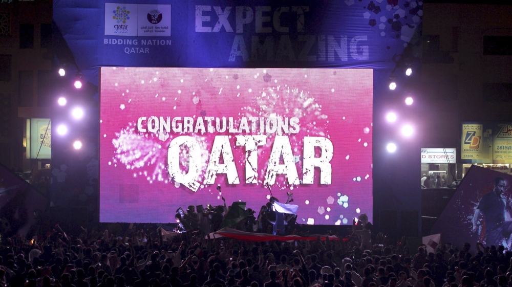 File photo of people celebrating in front of a screen that reads "Congratulations Qatar" after FIFA announced that Qatar will be host of the 2022 World Cup in Souq Waqif in Doha