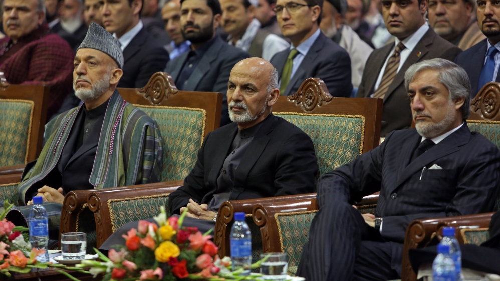 Ghani, Karzai and Abdullah during a ceremony marking the first anniversary of the death of Former Afghan Vice President Marshal Mohammed Qasim Fahim [AP]
