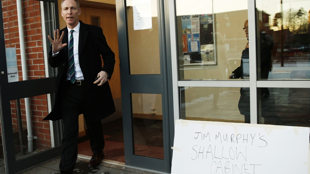 Scotland''s Labour Party leader Murphy passes a heckler''s placard while campaigning in Dundee, Scotland