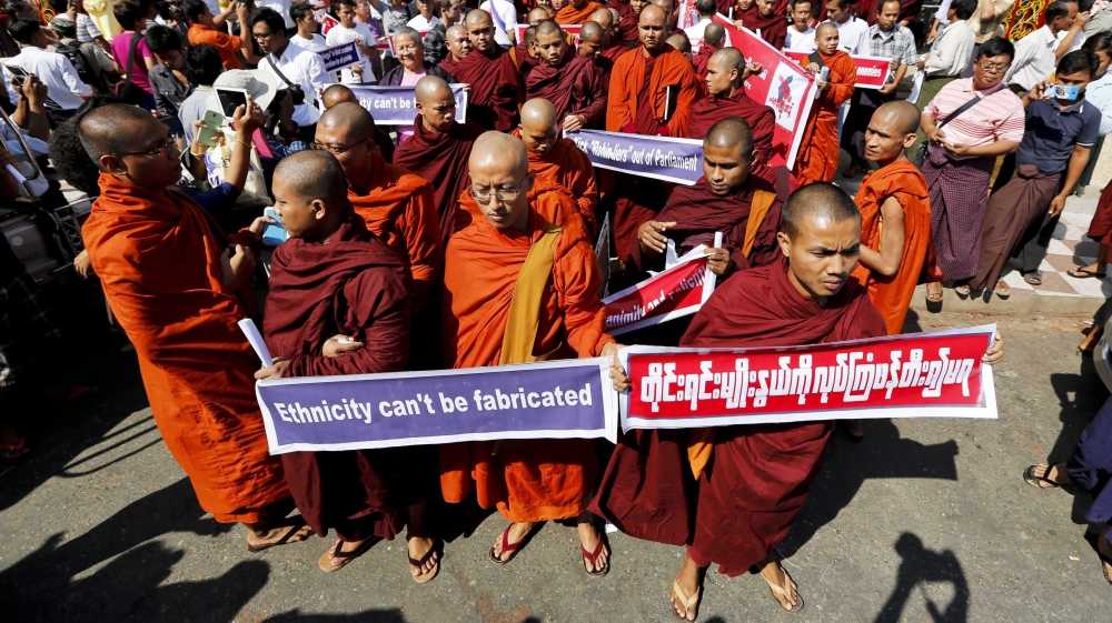 Buddhist monks carry placards during a protest against a UN resolution urging Myanmar to offer Rohingyas full citizenship, Yangon, Myanmar [EPA]