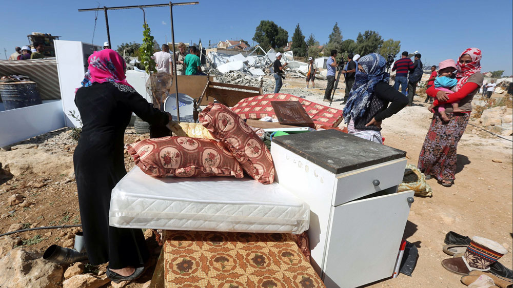 Bedouins on demolished home in Um Alkier