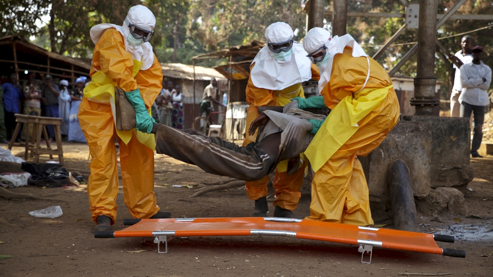 A French Red Cross team picks up a suspected Ebola case in Guinea