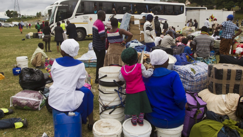 Foreigners from Zimbabwe wait to leave on a bus home, from a camp for those affected by anti-immigrant violence in Chatsworth, north of Durban