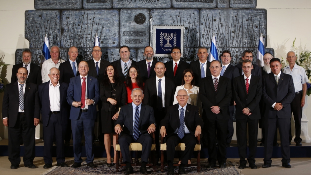 Members of the newly sworn in 34th government of Israel pose for a group photo at the presidential compound in Jerusalem on May 19, 2015 [Getty]