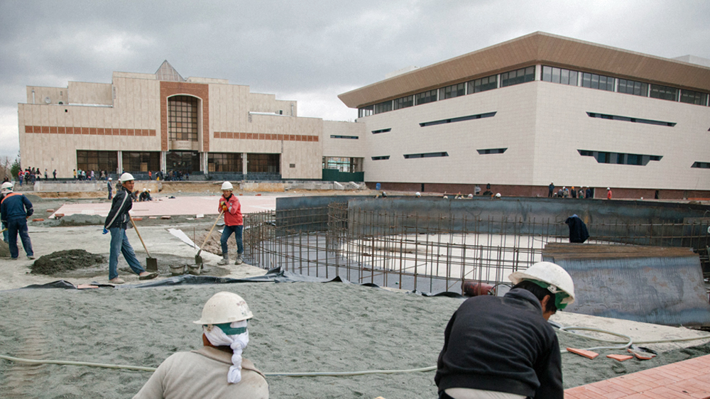 Construction workers near the Savitsky museum working to complete two museum buildings to mark Savitsky’s centenary [Timur Karpov/Al Jazeera]