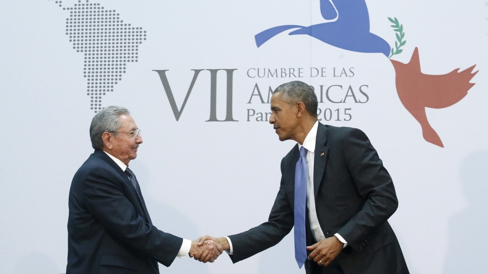 Obama shakes hands with Cuba''s President Raul Castro in Panama [REUTERS]