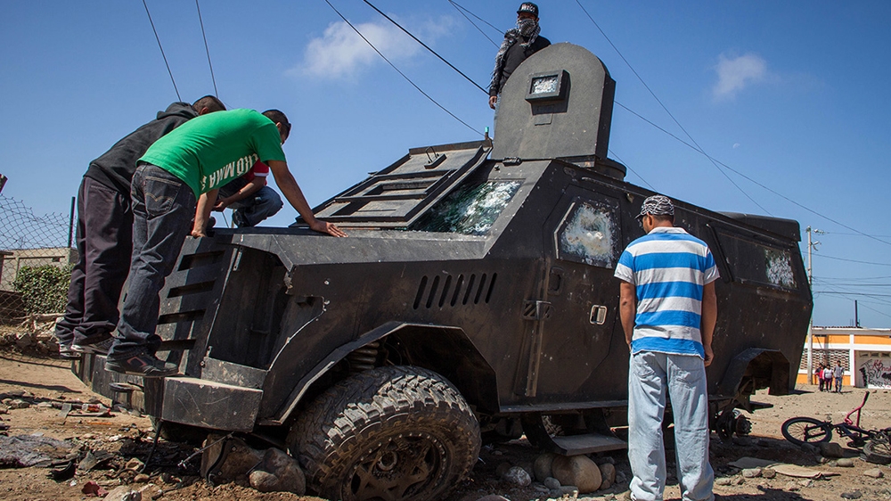 A police vehicle was destroyed during the violence over the weekend [José Pedro Martínez/Al Jazeera]