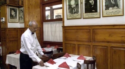 Egyptian waiter prepares a table at the historical Cafe Riche in Cairo [Getty]