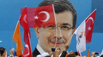 AKP supporters wave Turkish and party flags as they listen to Prime Minister Ahmet Davutoglu at an election rally [REUTERS]