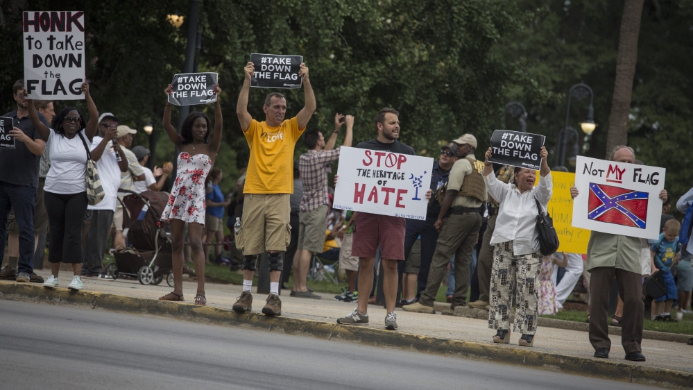 Activists are calling for the removal of the controversial flag from the grounds of the state house [EPA]