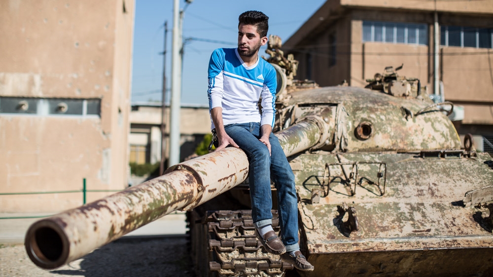 Sarkash sits on the turret of an old Saddam-era tank in Sulaymaniyah's Red Museum.