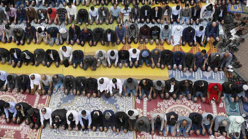 Muslims attend Friday prayers during the second day of Ramadan, in the courtyard of a housing estate next to the small BBC community centre and mosque in east London