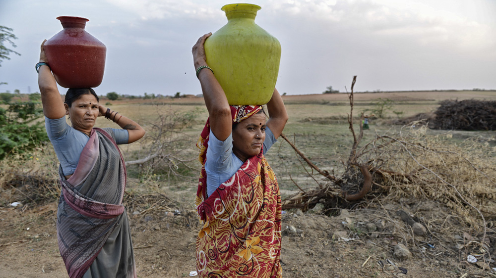 The villagers must carry water from a well to their homes as running water is unavailable in the village [Zigor Aldama/Al Jazeera]