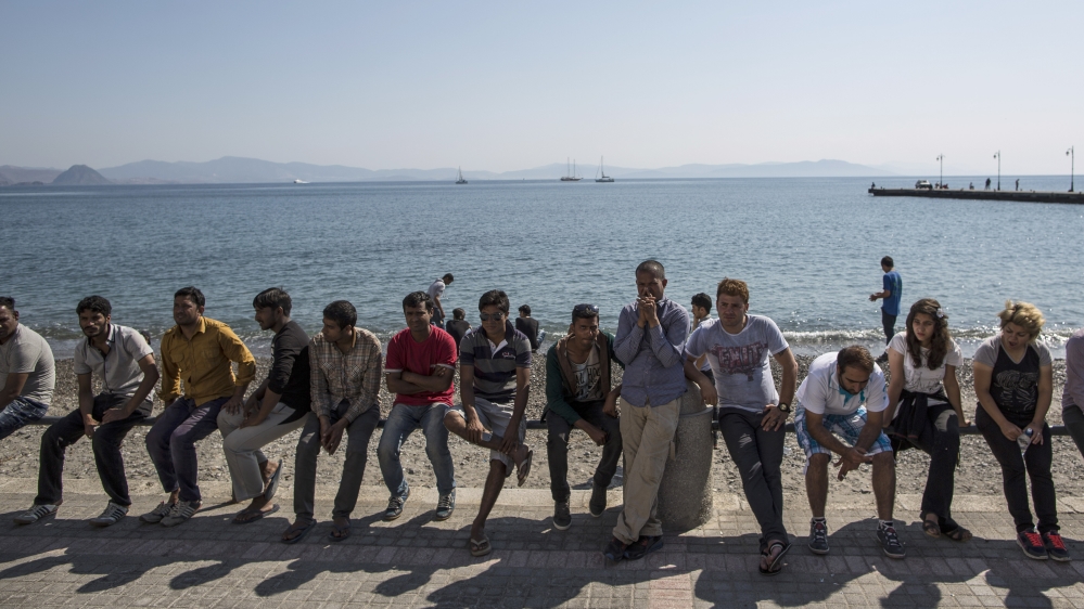 Migrants gather outside the police station to collect documentation to facilitate their onward journey into Europe [Getty]