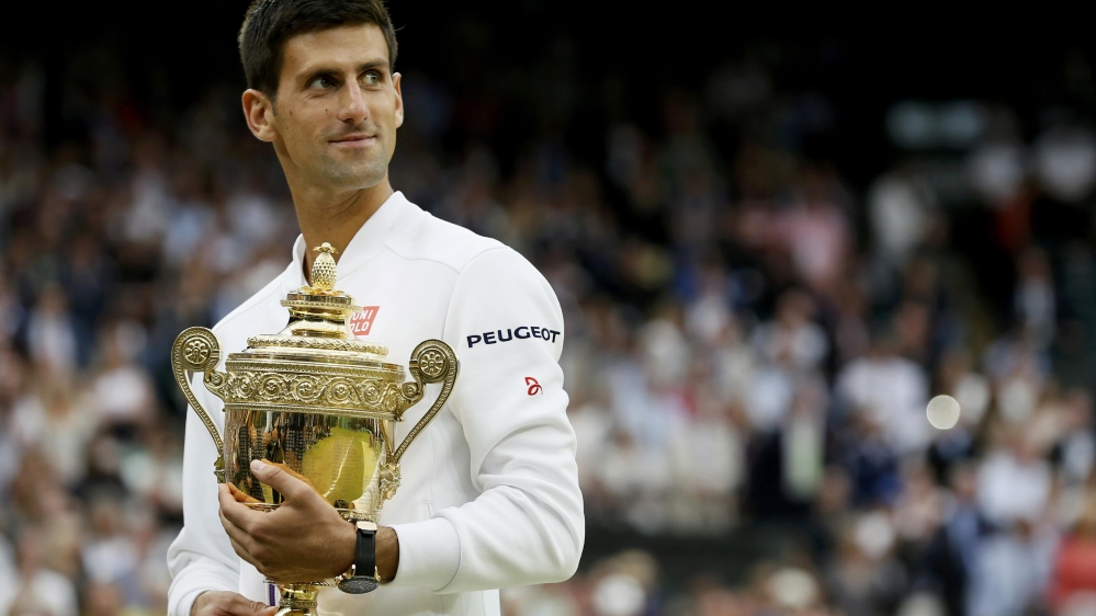 Novak Djokovic holds the trophy after winning his Men''s Singles Final match at the Wimbledon Tennis Championships in London